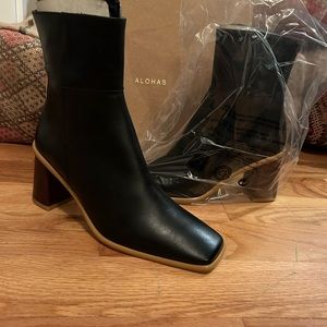 Black leather ankle boots with natural wood accents. 3” heel size 40 (US 9)